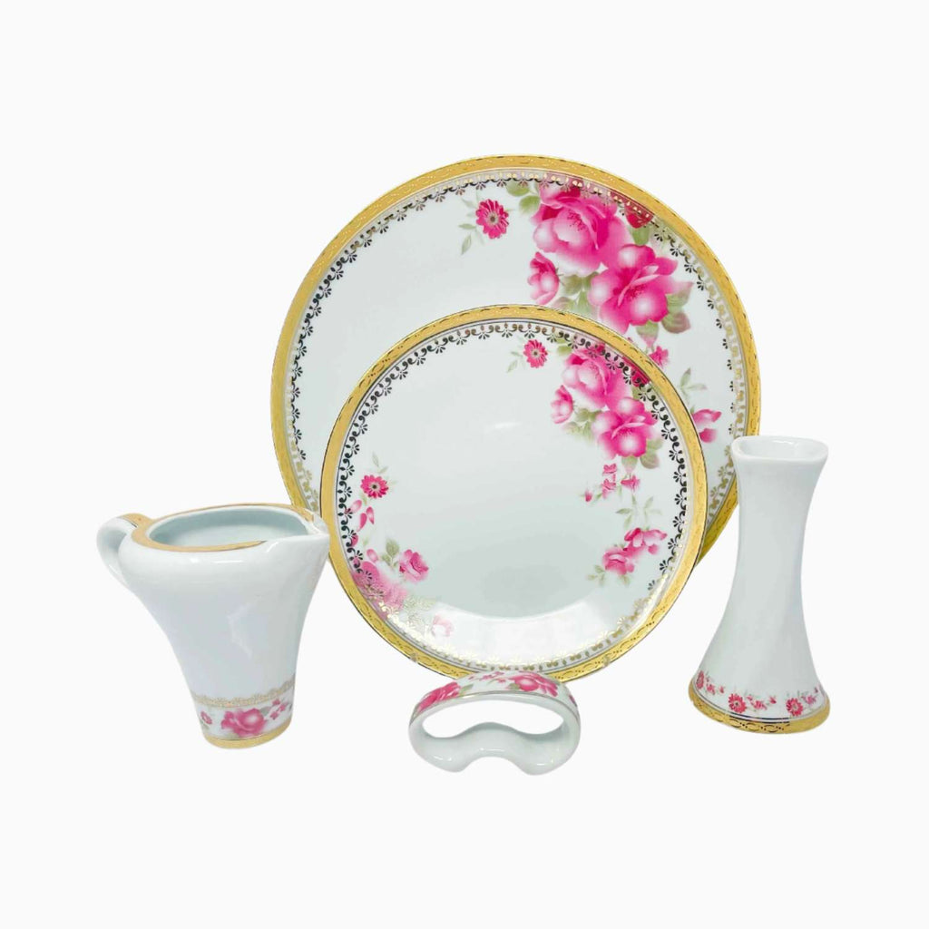 Set of ceramic tableware with floral design on a white background
