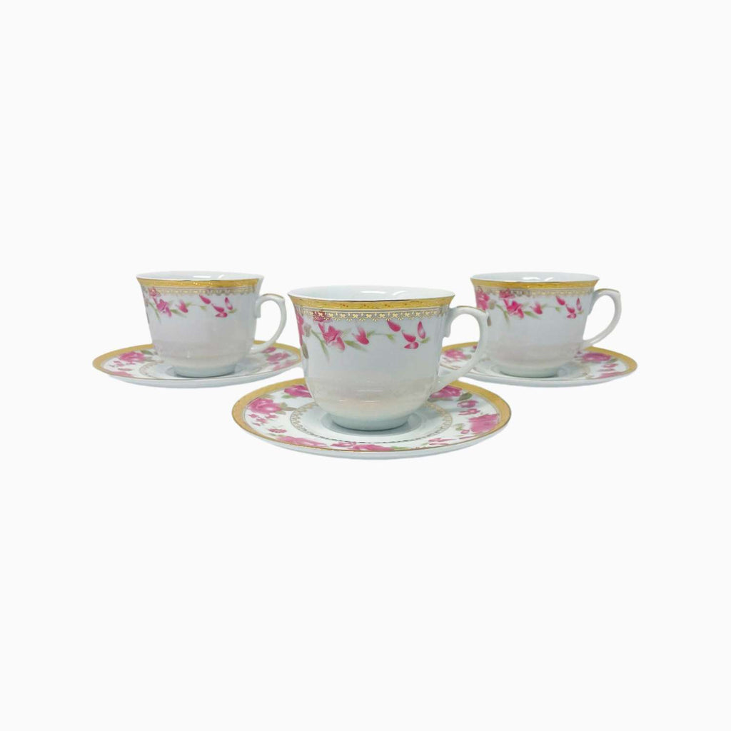 Set of three ceramic teacups with floral patterns on saucers against a white background