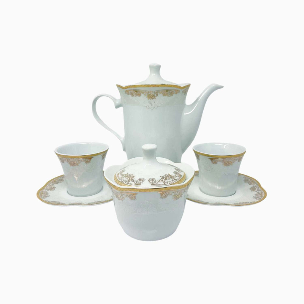White ceramic tea set with gold accents on a white background