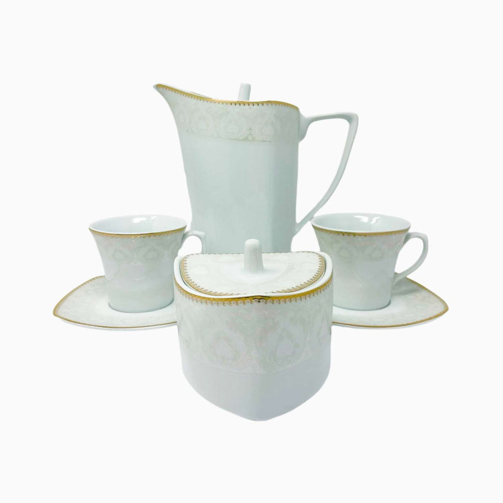 White ceramic tea set with gold accents on a white background