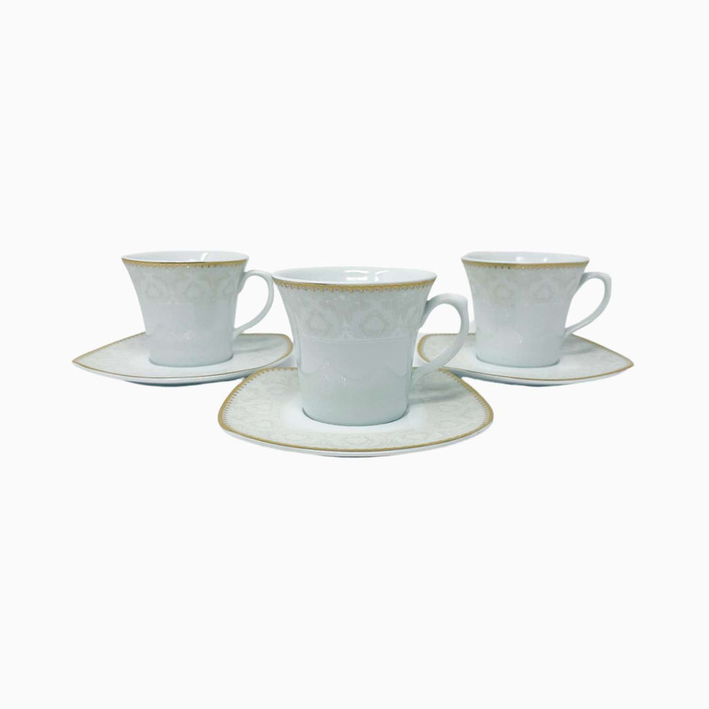 Set of three white teacups with gold rims and saucers on a white background