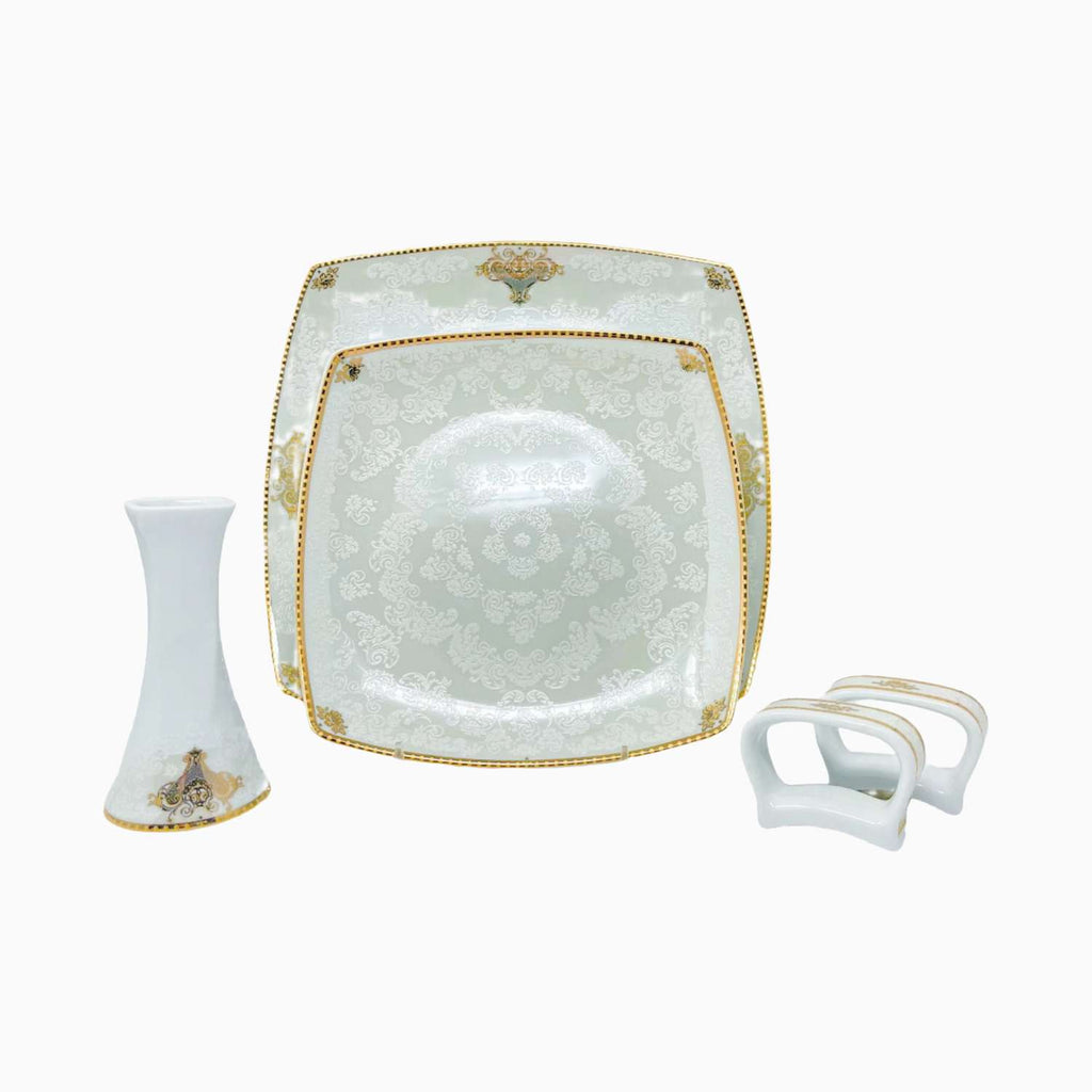 Decorative white plate with gold accents on a white background
