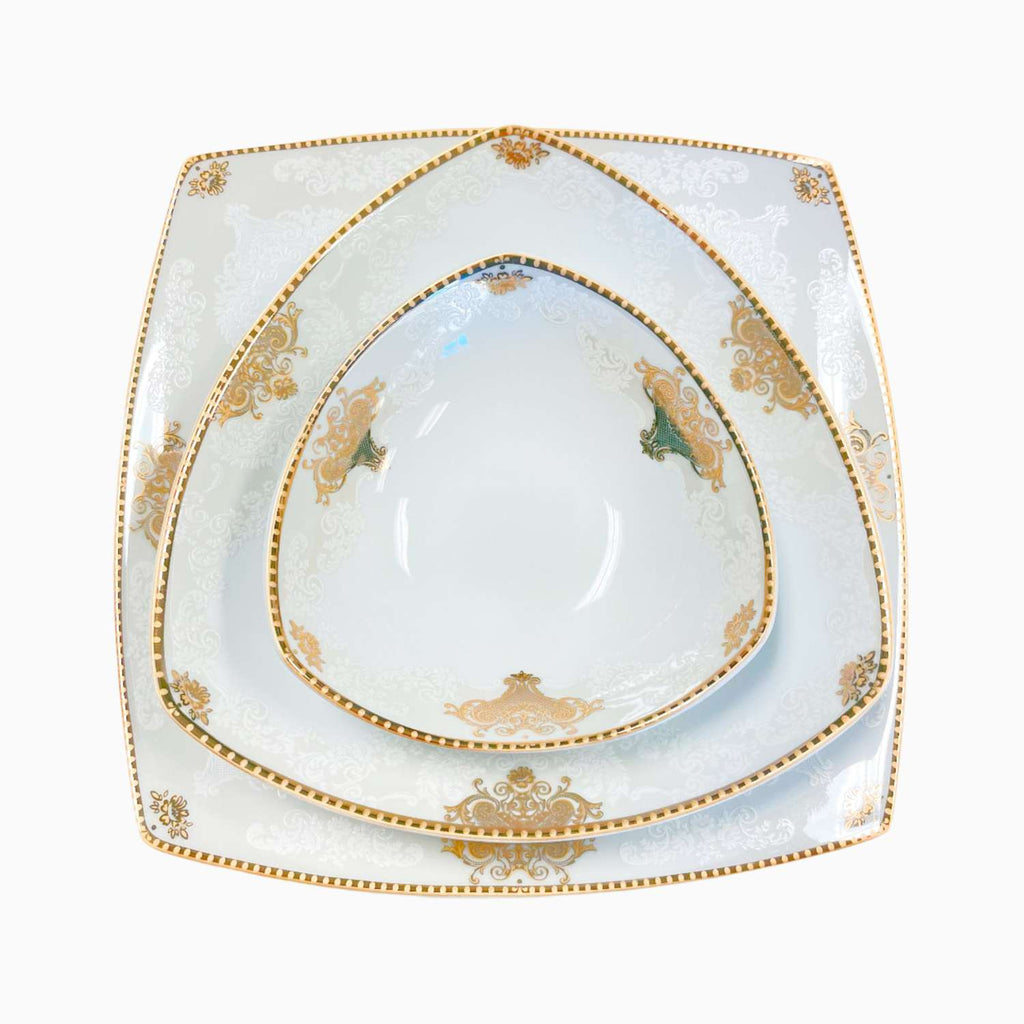 Set of white plates with gold decorative patterns on a white background
