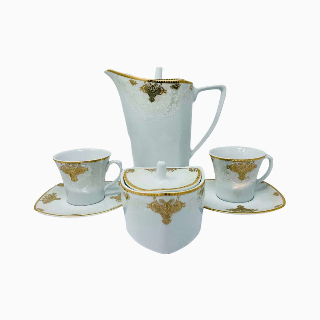 White ceramic tea set with gold accents on a white background