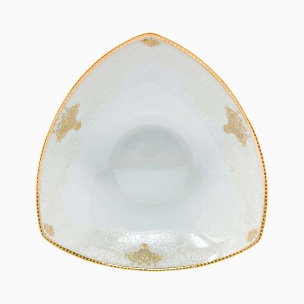 Triangular white bowl with gold decorative elements on a white background