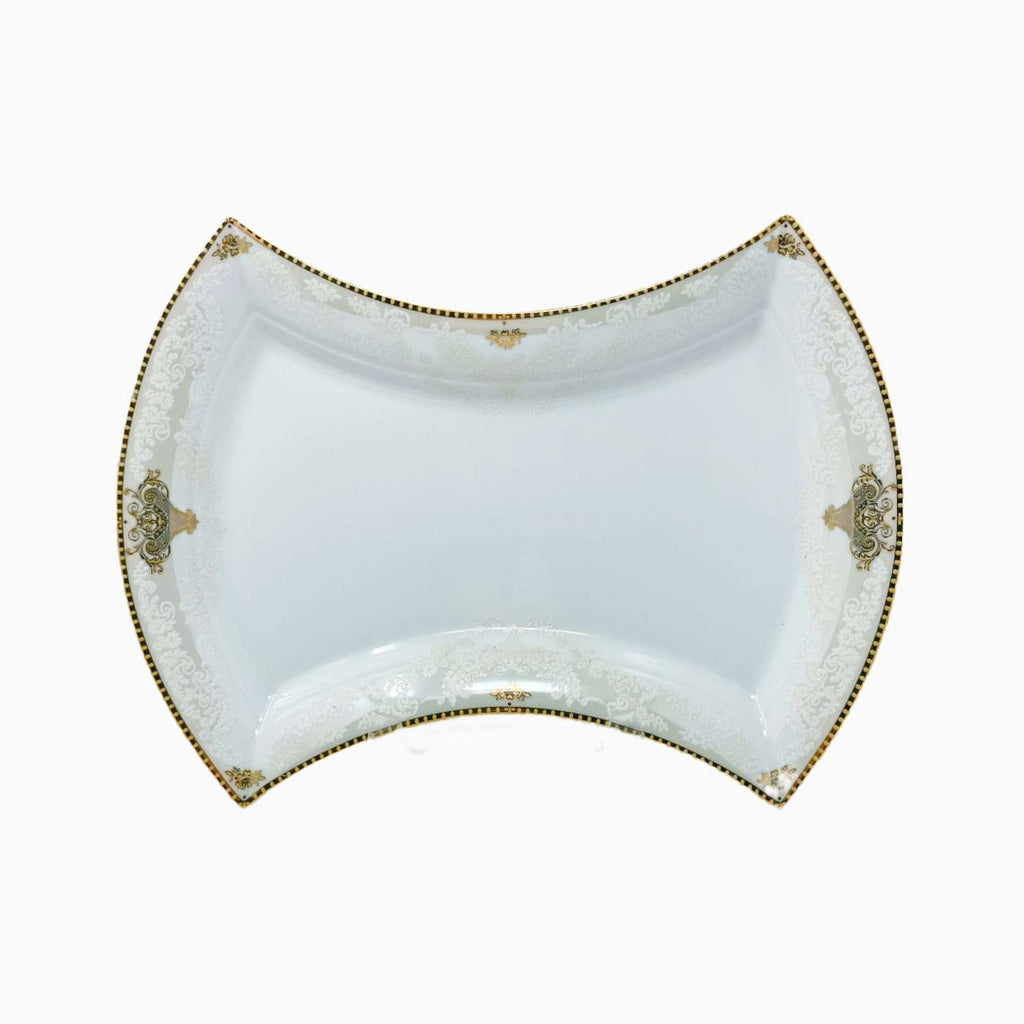 Decorative white dish with gold accents on a white background