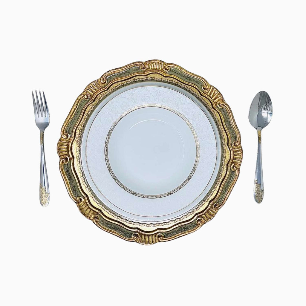 Decorative plate with gold rim and silverware on a white background