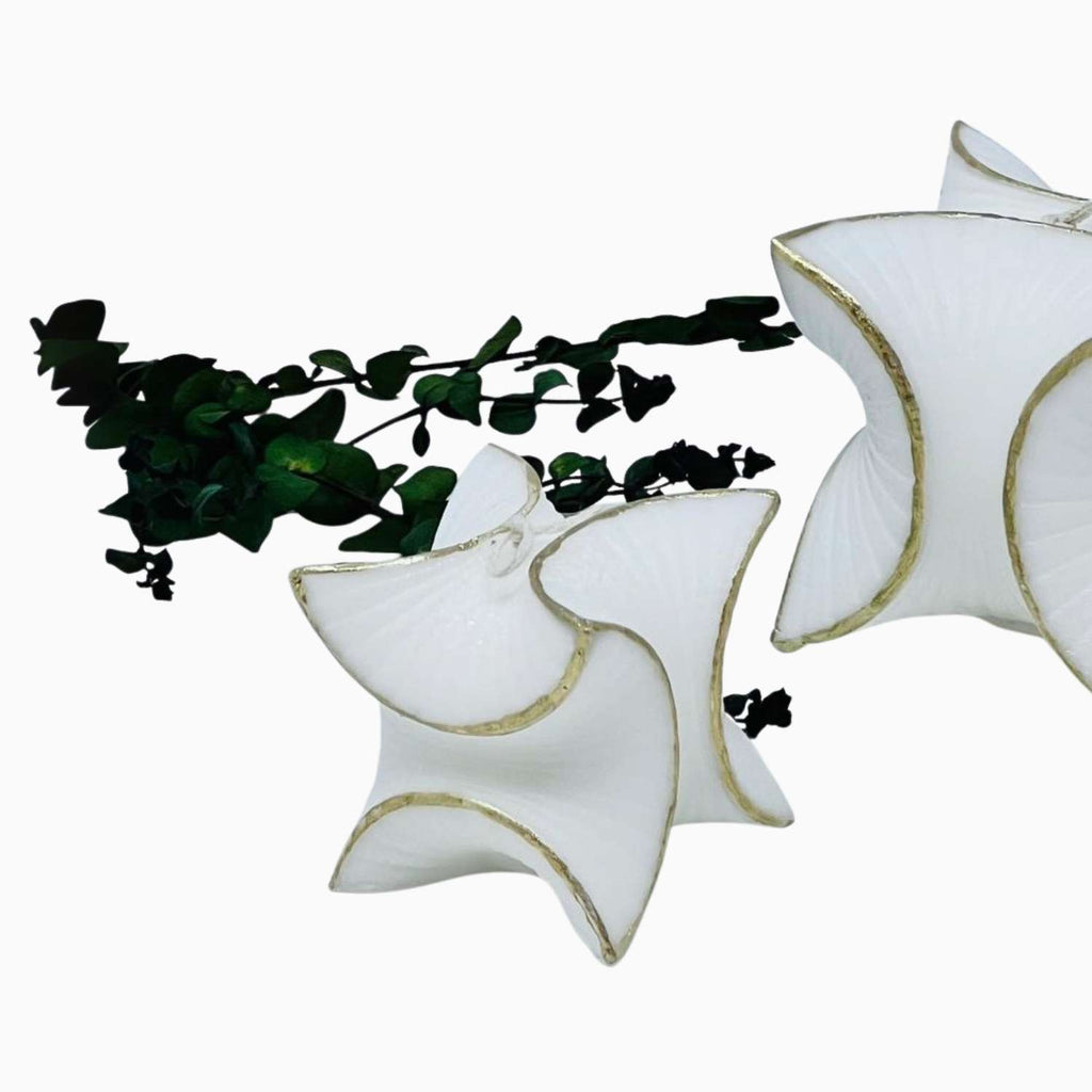 White star-shaped ceramic CANDLES with gold accents on a white background