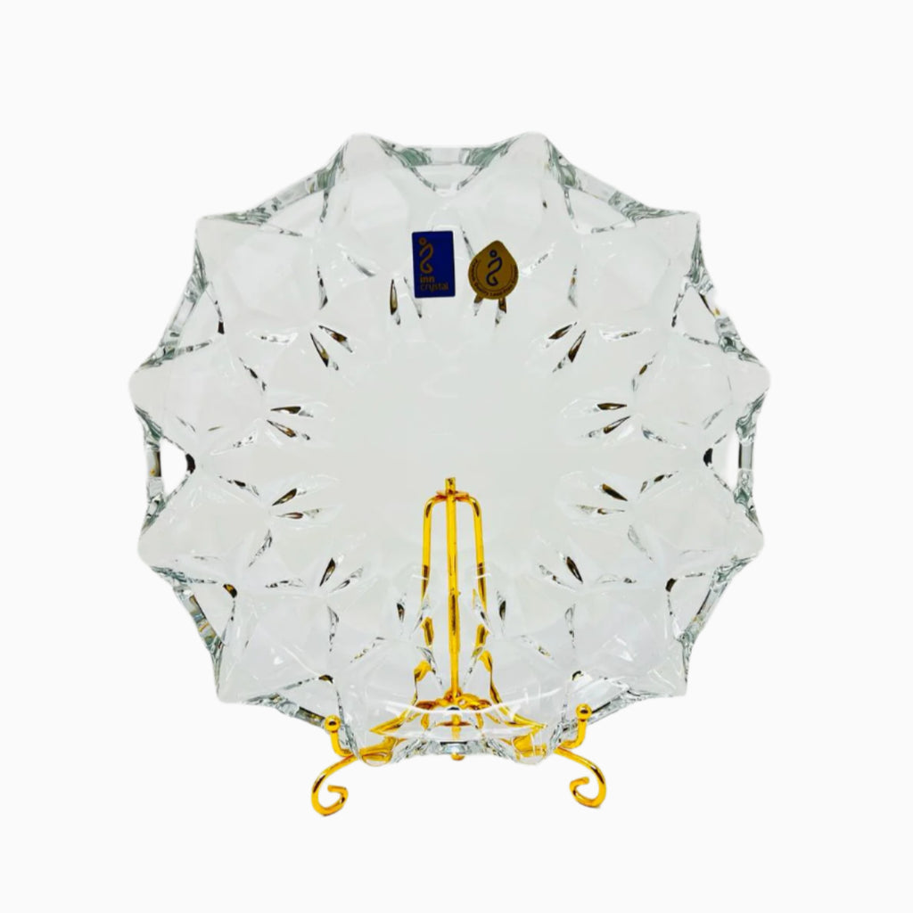 A clear glass dessert plates with a geometric pattern.