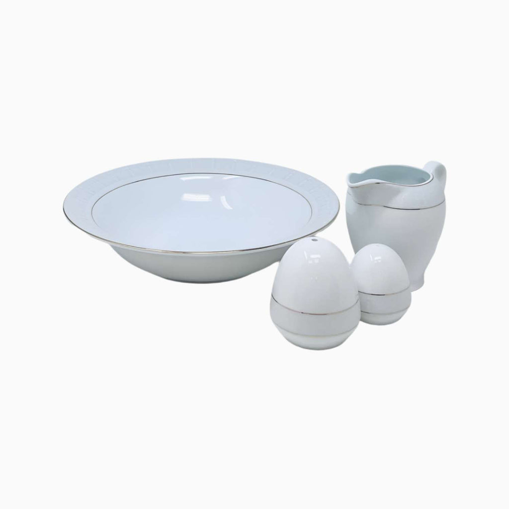 Set of white ceramic bowls and a pitcher on a white background