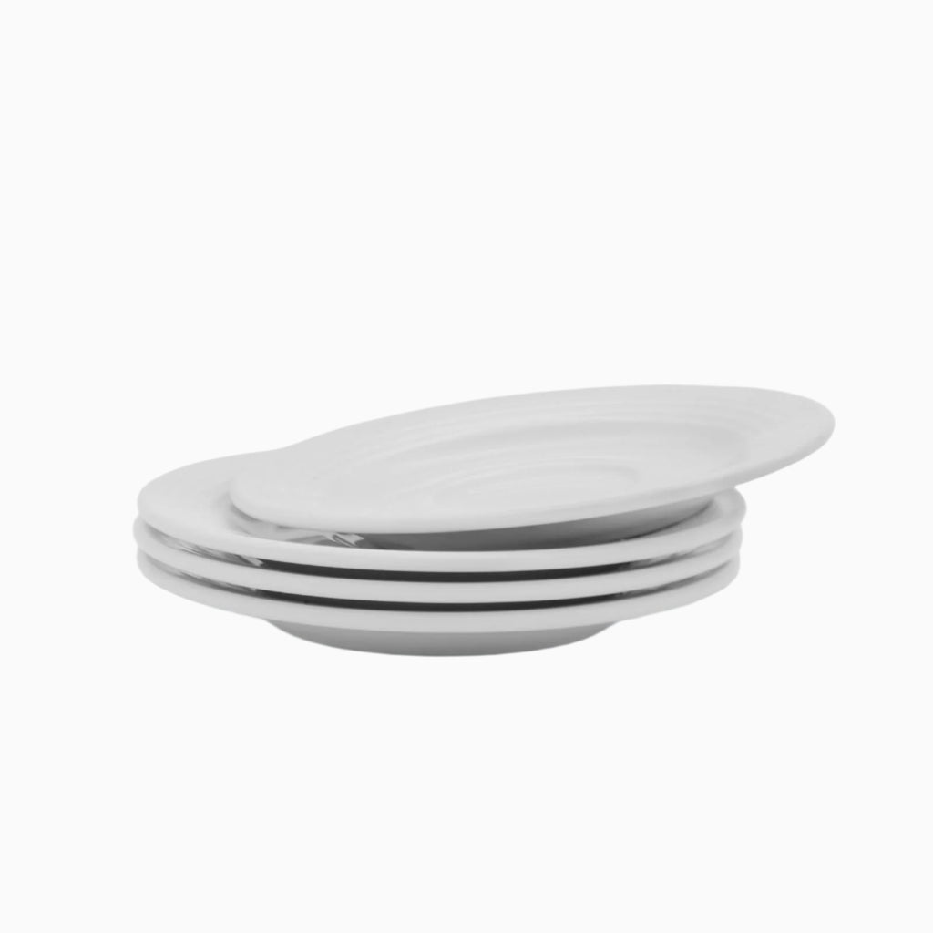 Stack of white ceramic plates on a light gray background