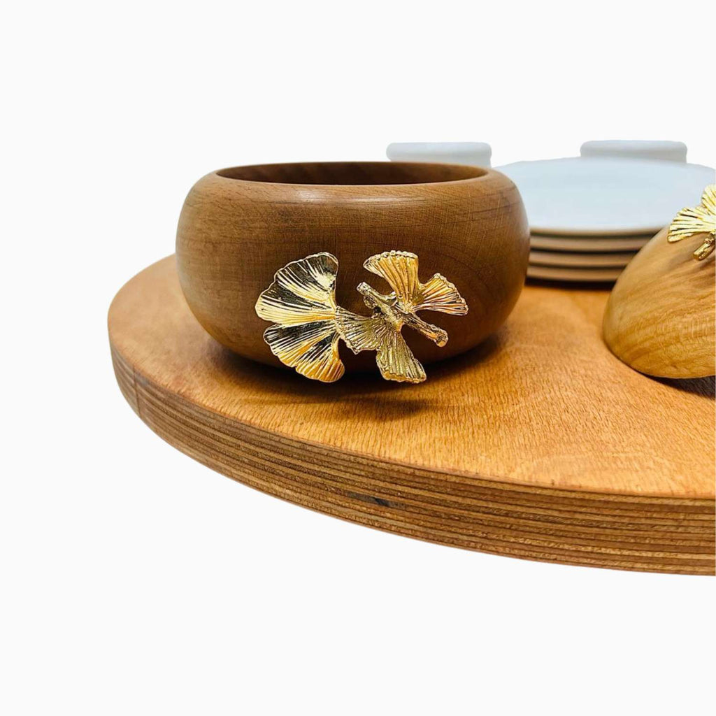 Wooden bowl with ginkgo leaf designs on a wooden tray