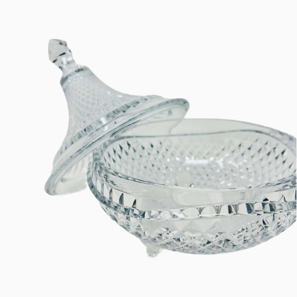 Clear glass candy bowl with lid on a white background