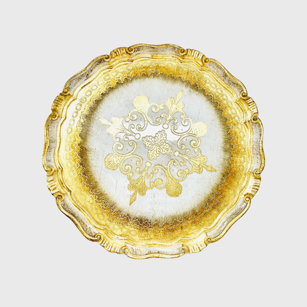 A circular, hand-painted wooden tray with intricate gold detailing