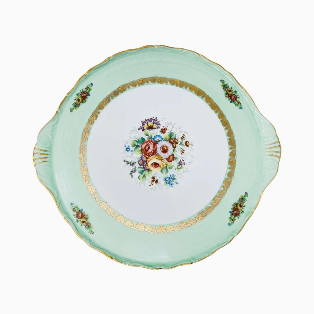 Decorative plate with floral design and gold trim on a white background