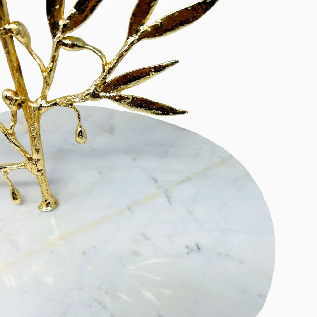 Gold leaf decorative item on a white marble dish