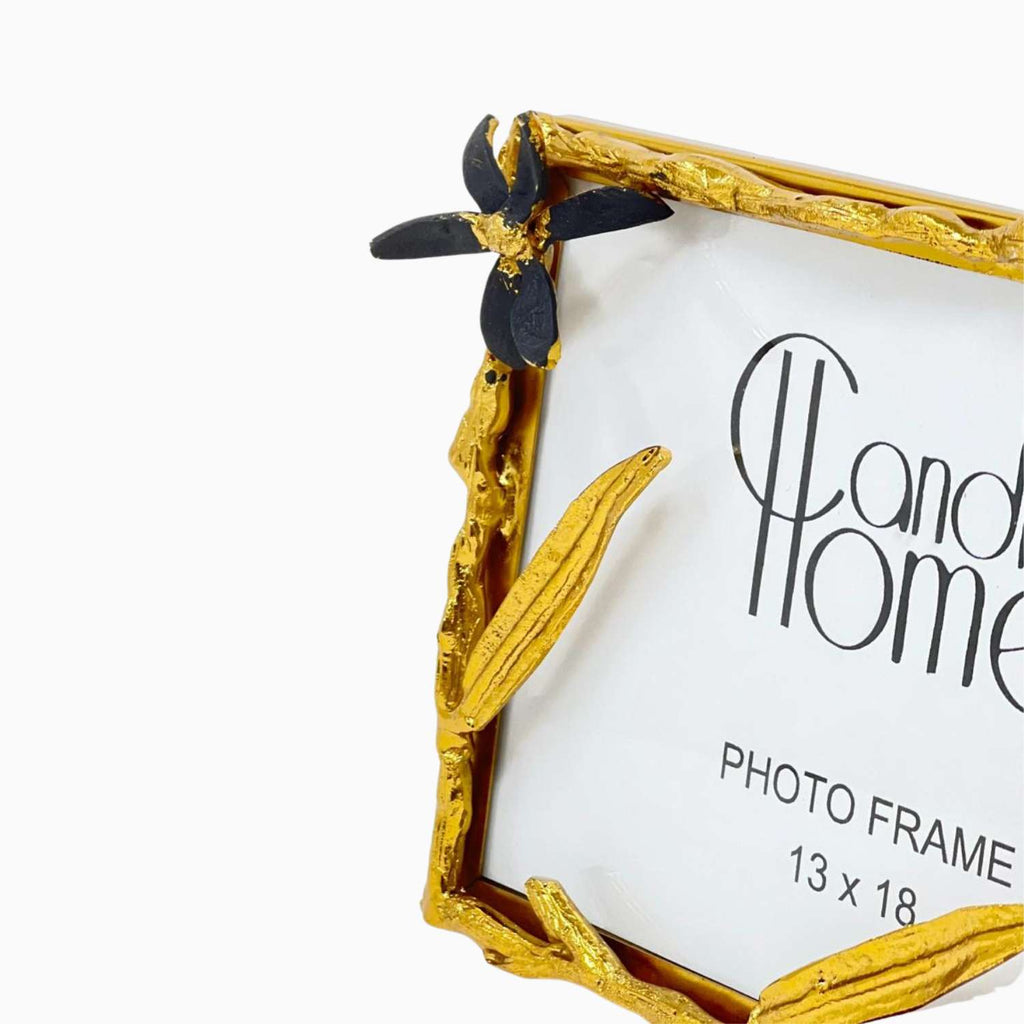 Gold photo frame with decorative elements on a white background