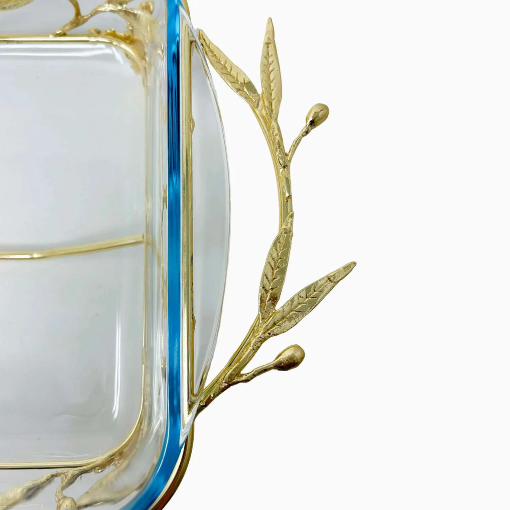 Clear glass dish with gold leaf design on a white background