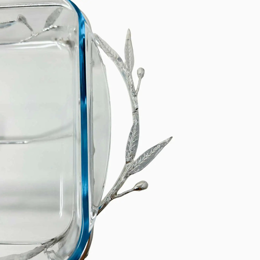 Clear glass dish with silver leaf design on a white background