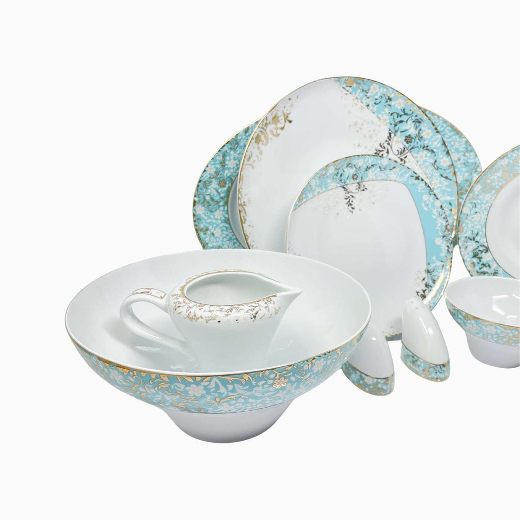 Set of ceramic dinnerware with decorative blue and gold patterns on a white background