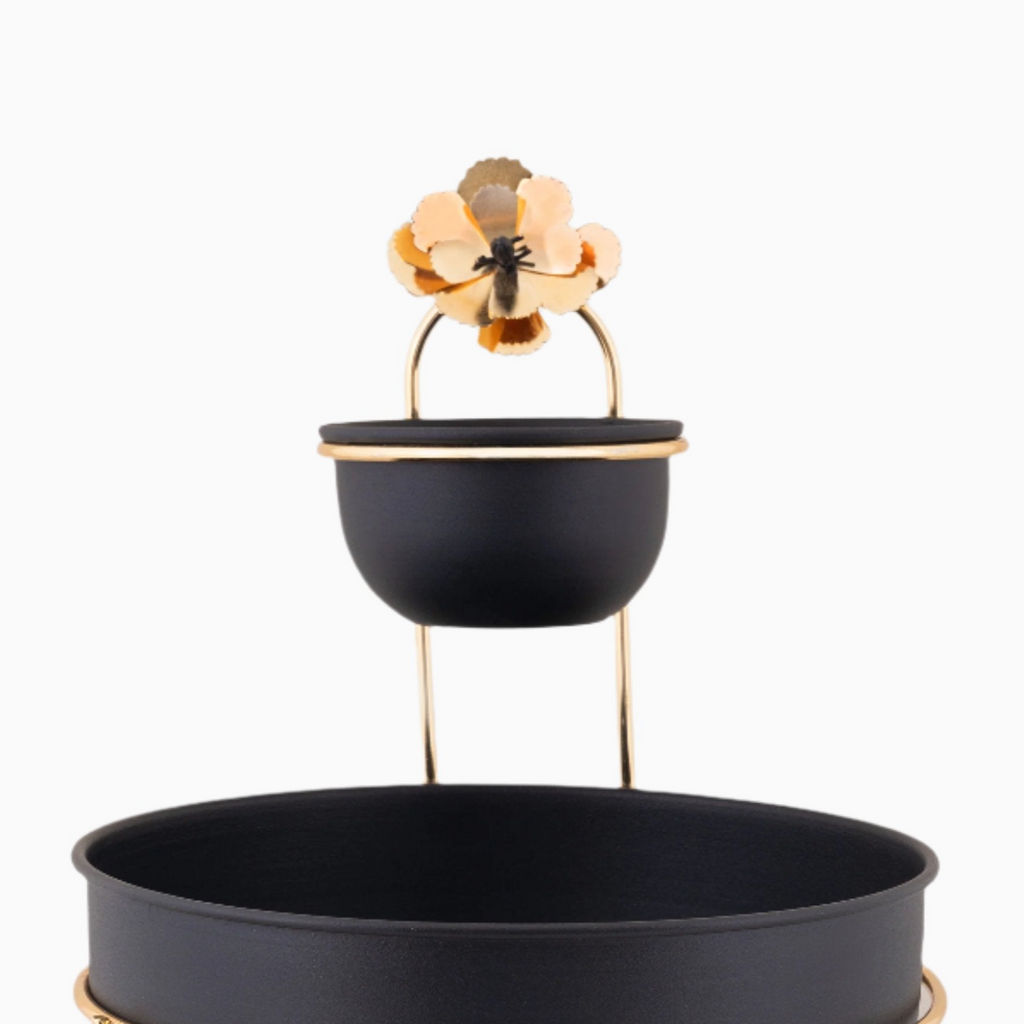TWO TIERED BLACK AND GOLD SERVING BOWL ON GOLD TONE STAND