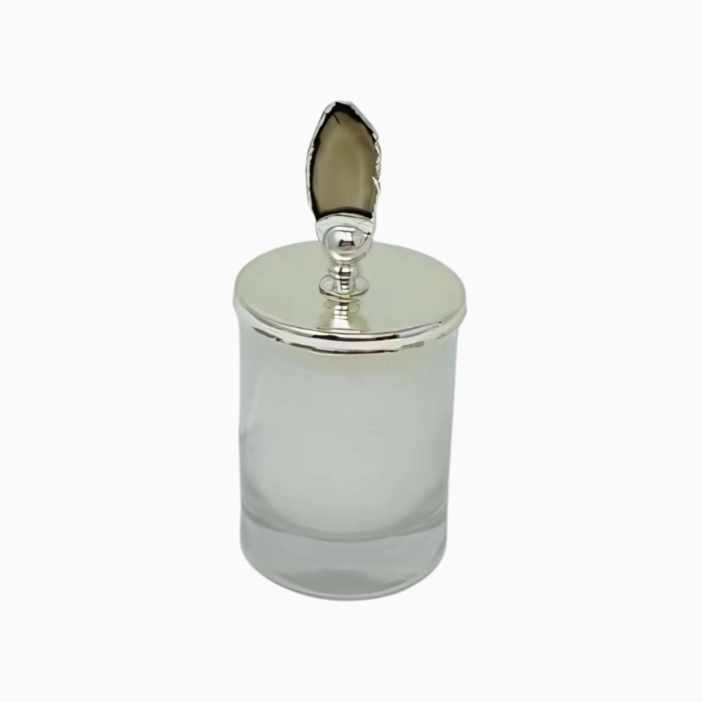 Clear glass jar with silver lid on a white background