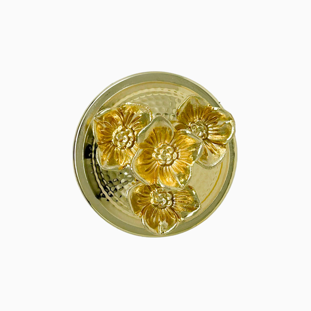 Gold decorative lid
 with floral design on a white background