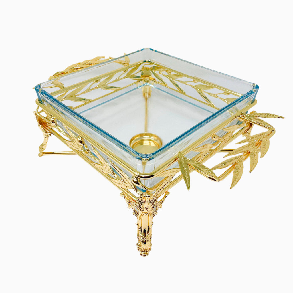Elegant square glass Pyrex serving dish set in an intricately crafted silver-tone metal stand featuring detailed leaf motifs and sculpted legs. Noble Home Gifts