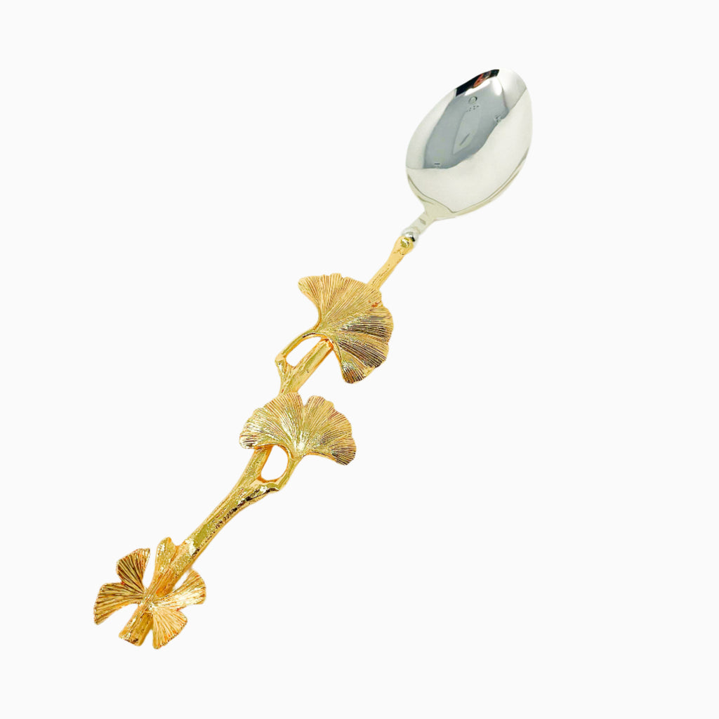 Gold salad spoon with butterfly detail.