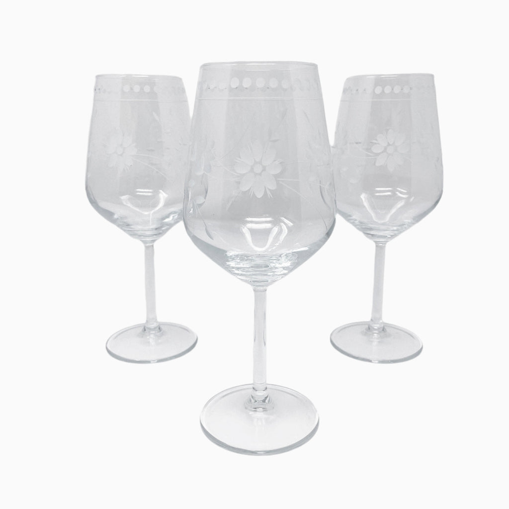 WHITE FLORAL DECORATED WINE VESSEL AND SIX PIECE GLASS SET